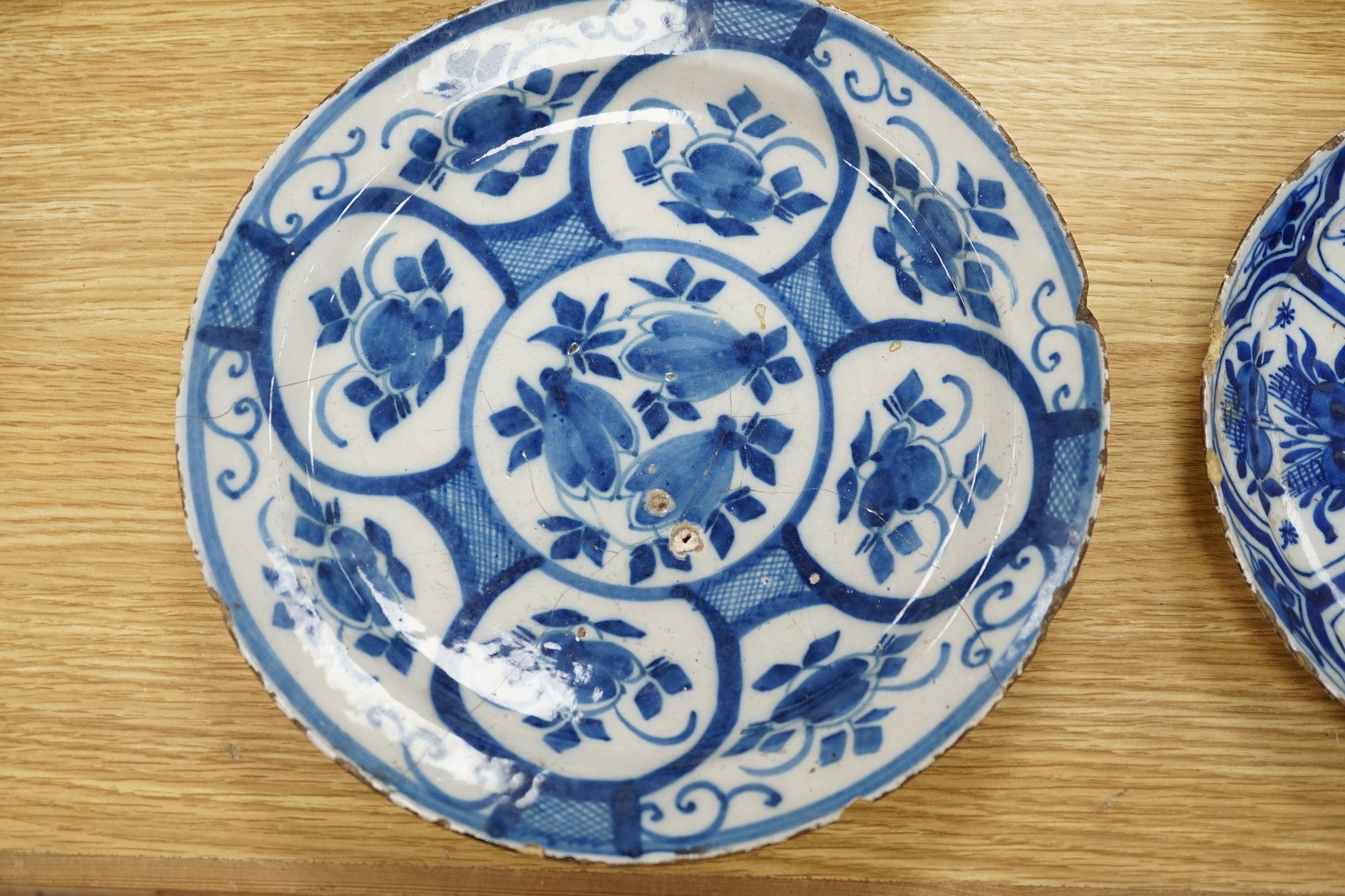 Four various continental delftware dishes, 18th and 19th century, largest 31cm diameter. Condition - various cracks and chipping to edges